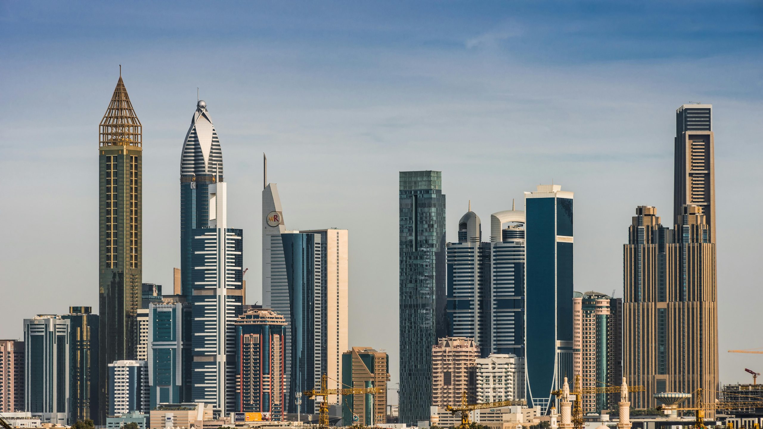 A stunning view of Dubai's modern skyline, showcasing iconic skyscrapers under a clear blue sky.